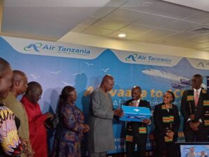 Photo - Professor Makame Mbarawa, Tanzanian CCM Politician and MP hands over package to business entourage